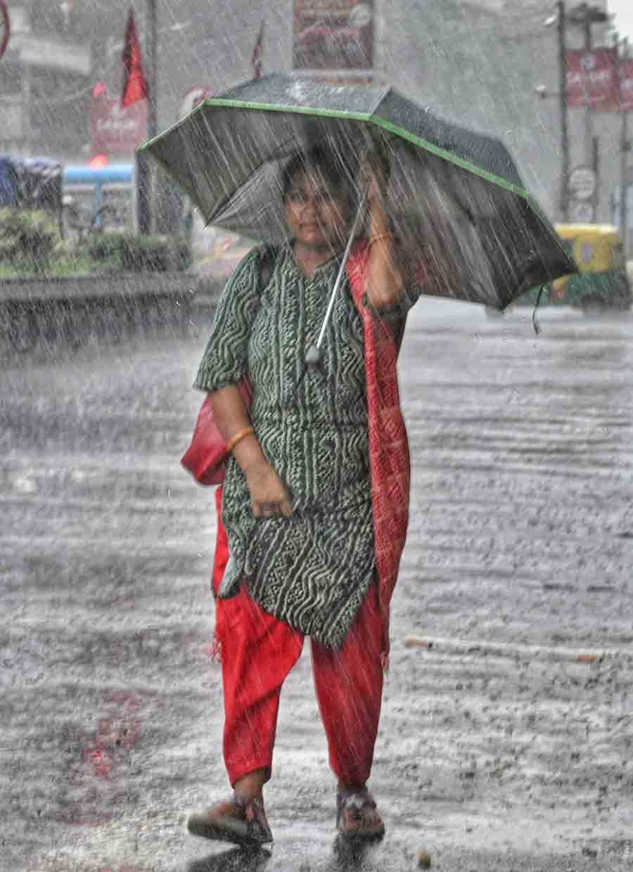 A woman caught in sudden rain in north Kolkata on Friday afternoon