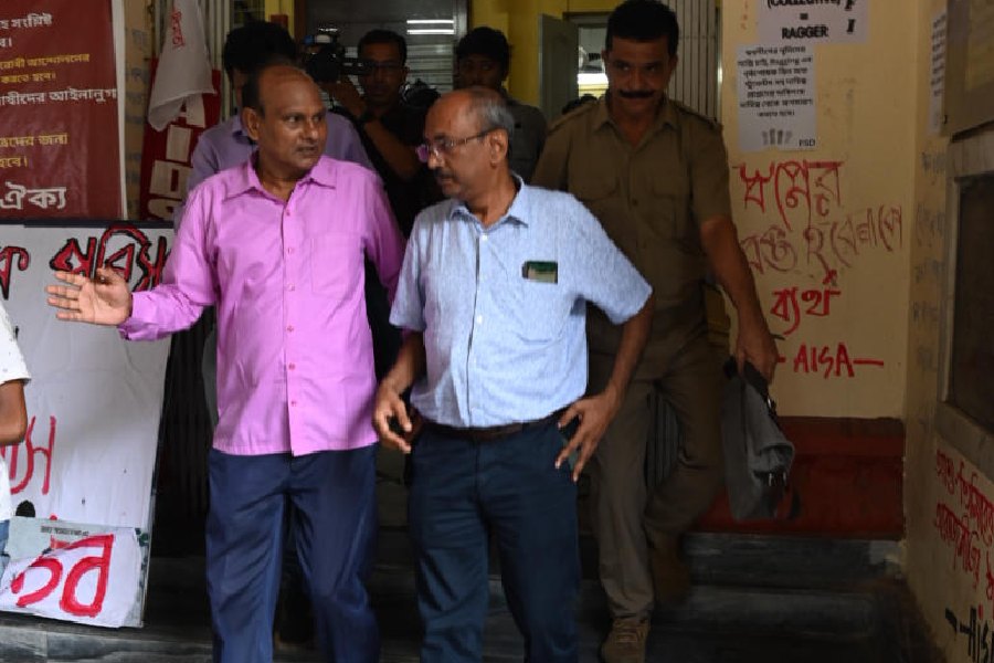 The new officiating vice-chancellor of Jadavpur University, Buddhadeb Sau (right), leaves Aurobindo Bhavan after the meeting on Monday.