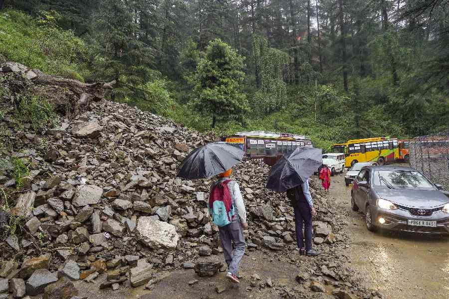 Debris blocks a road following incessant monsoon rainfall