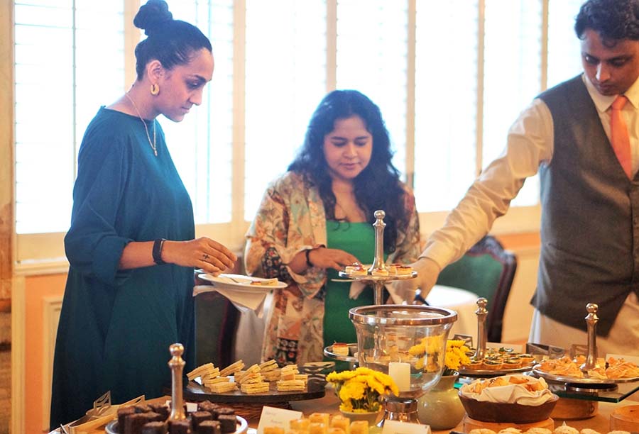 Guests (left) Karuna Parikh and Shabba Hakim enjoy the high tea
