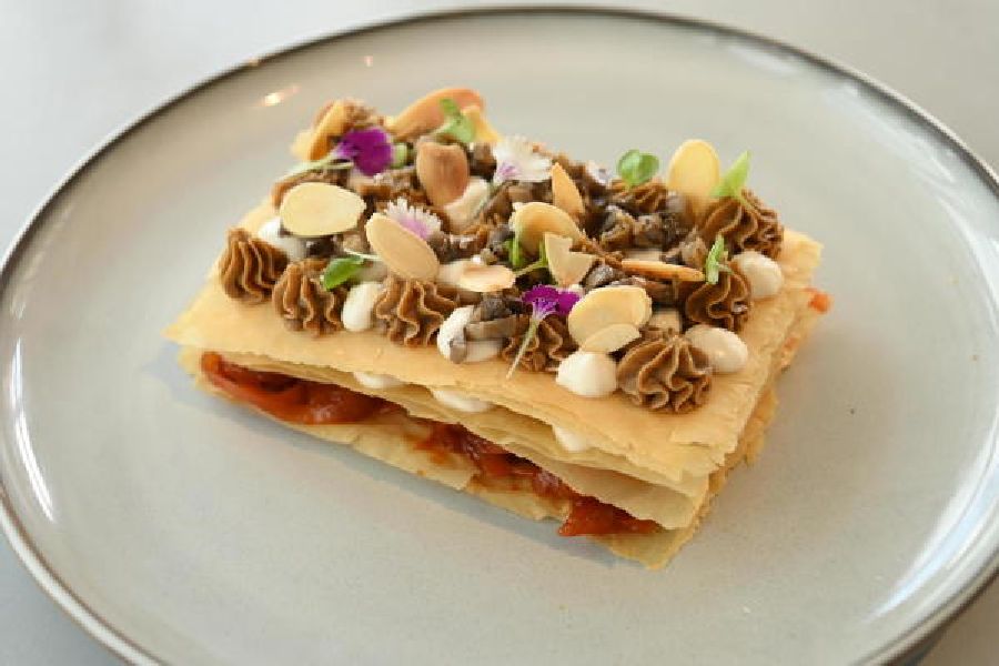 Mushroom Mille Feuille: A umami spin on the classic dessert, here we have mushrooms, mushroom cream, Parmesan and onions laced with tomato paste between layers of phyllo pastry. A great balance of flavours and textures.
