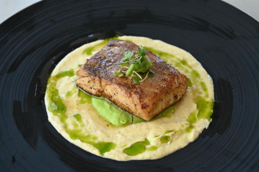 Brown Butter Braised Fish: Bhekti fish is cooked in a brown butter sauce and served with a relish pea purée and some leek cream. We love the texture of the cream.