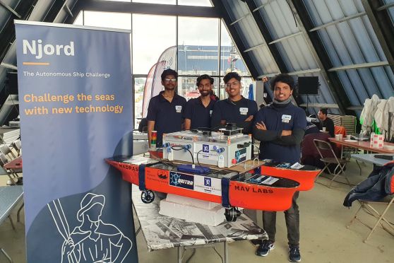 The four students of Team Aritra, IIT Madras, with their autonomous ship at The Njord Challenge 2023 competition held recently in Norway