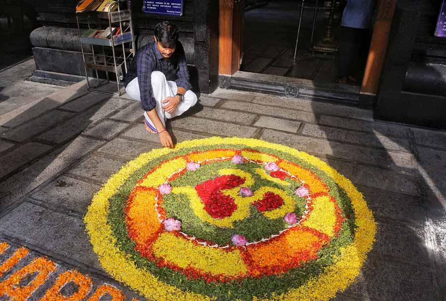 A colourful pookolam being made at the entrance of Sree Guruvayurappan Temple near Kalighat to welcome devotees early on Tuesday 