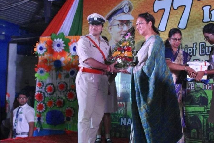A police officer is being felicitated at the Independence Day celebrations at St Augustine Day School Barrackpore