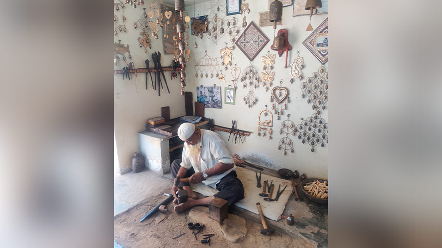 Luhar Husen hammering bells out of metals 