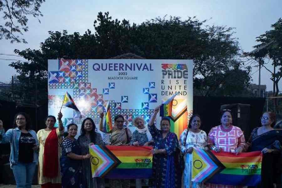 Parents of queer individuals hold up the LGBTQIA+ flags. They attended Queernival 2023 to express their support for the event and the community