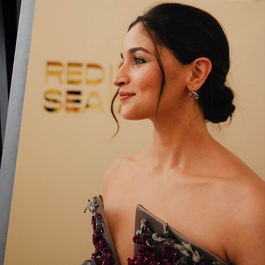 Dainty earrings, a messy bun and loose strands of hair elegantly framing her face completed her look.