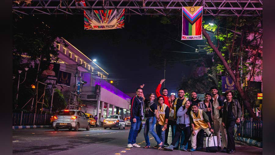 Volunteers of Kolkata Pride under the Pride flag on Park Street