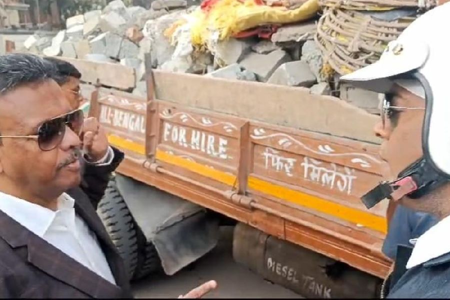 Mayor Firhad Hakim stops the construction waste-laden truck on Monday