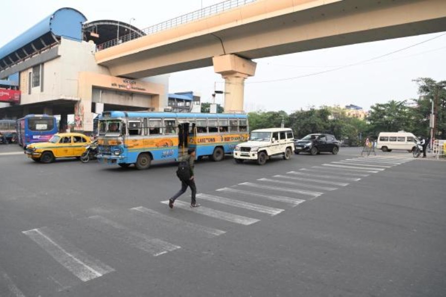A pedestrian crosses EM Bypass amid traffic at the Avishikta crossing on Thursday