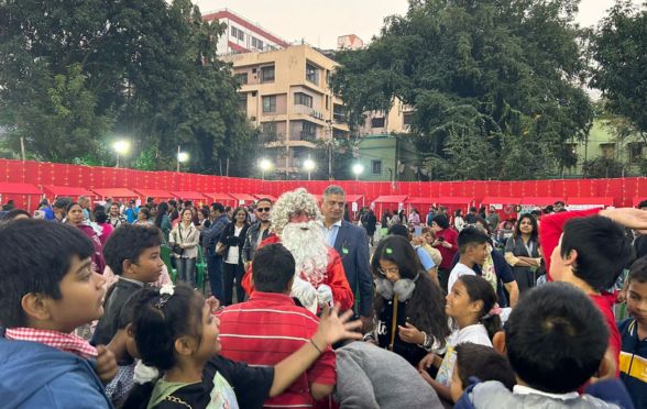 Children crowd to gather gifts from Santa Clause