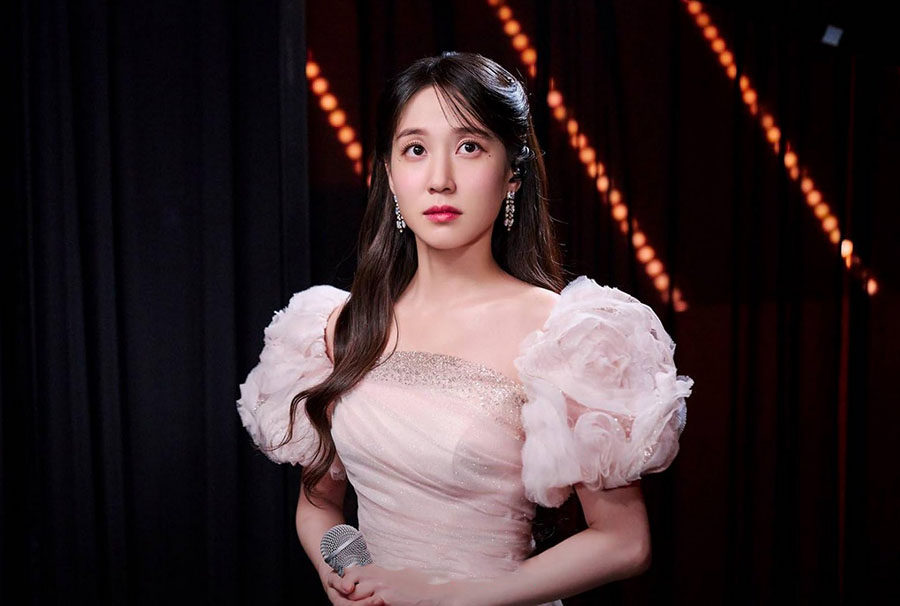 Still crushing on Barbiecore? Take inspiration from Park Eun-bin’s pink sheer mini dress with silver embellishments which she wore before her concert in Castaway Diva (2023), streaming on Netflix. 