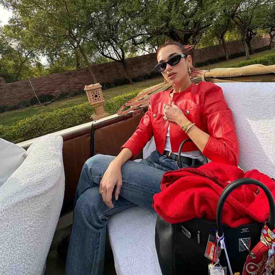During another outing, Dua paired her red leather jacket with a white tee and jeans. 