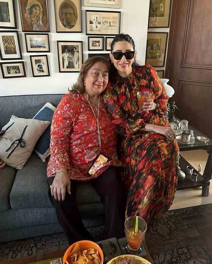 Karisma Kapoor posed for a picture with her mother Babita. While Karisma looked gorgeous in a colourful collared maxi dress, Babita chose a simpler outfit — a red kurta paired with black trousers. 