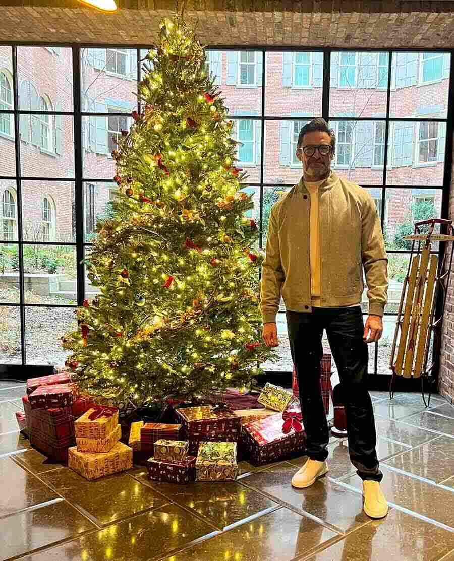 Hugh Jackman posed for a picture against a lit-up Christmas tree. Sporting a casual look, the X-Men actor was in a grey bomber jacket, which he paired with black trousers and white skate shoes.