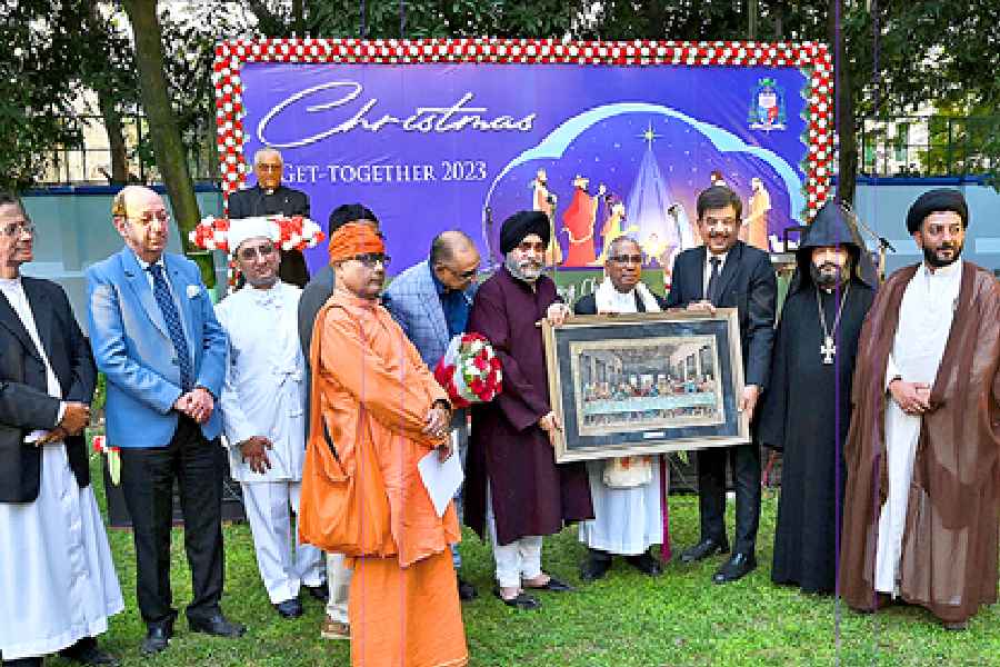 Representatives of various faiths present a tapestry depicting the Last Supper to the archbishop of Calcutta, Reverend Thomas D'Souza, on Wednesday.