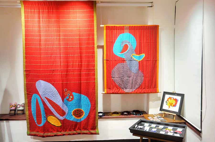 Vibrant colours and abstract motifs stand out as key elements in Shohini’s artwork. This multipurpose upcycled ‘kantha’ piece, crafted from hand-stitched fabrics and saris, can serve as both home decor and a cosy throw. The artist intentionally keeps her works versatile, leaving room for audience interpretation. Shohini’s aesthetic juxtaposes minimalism with the richness of hues, creating an interesting contrast in many of her pieces