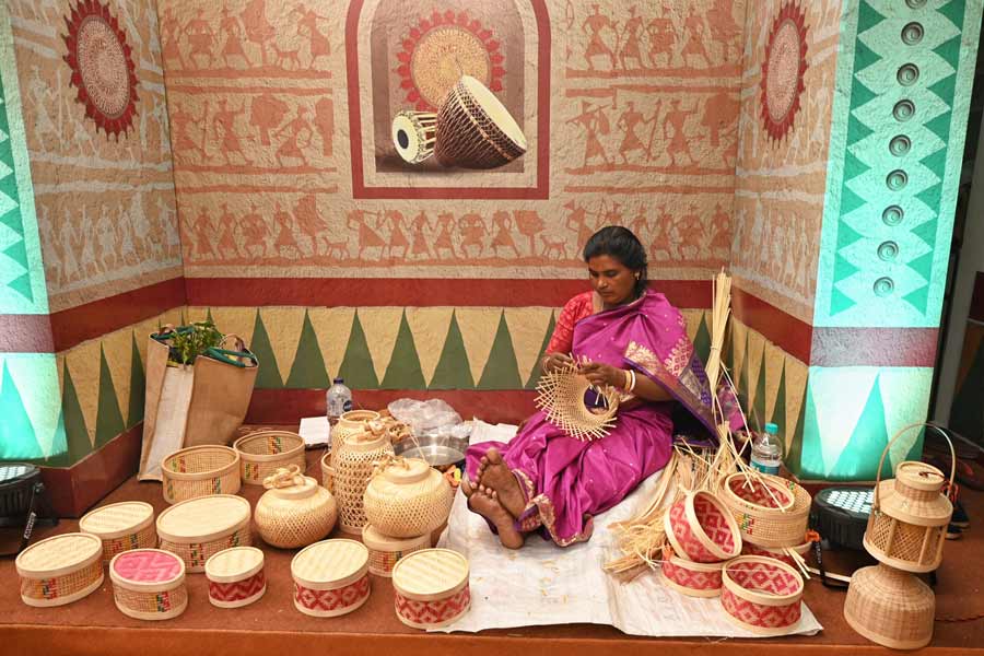 An artist is busy weaving a basket at the Biswa Bangla Lok Sanskriti Utsav at Rabindra Sadan. The 8-day festival will end on January 1, 2024