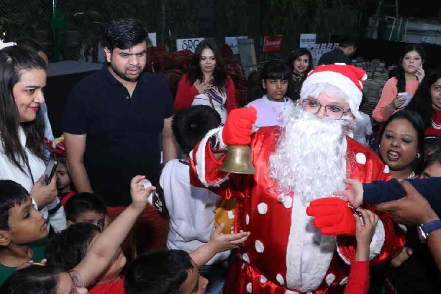 Club member Sajeev Roy dressed up as Santa Claus was swarmed by the kids.