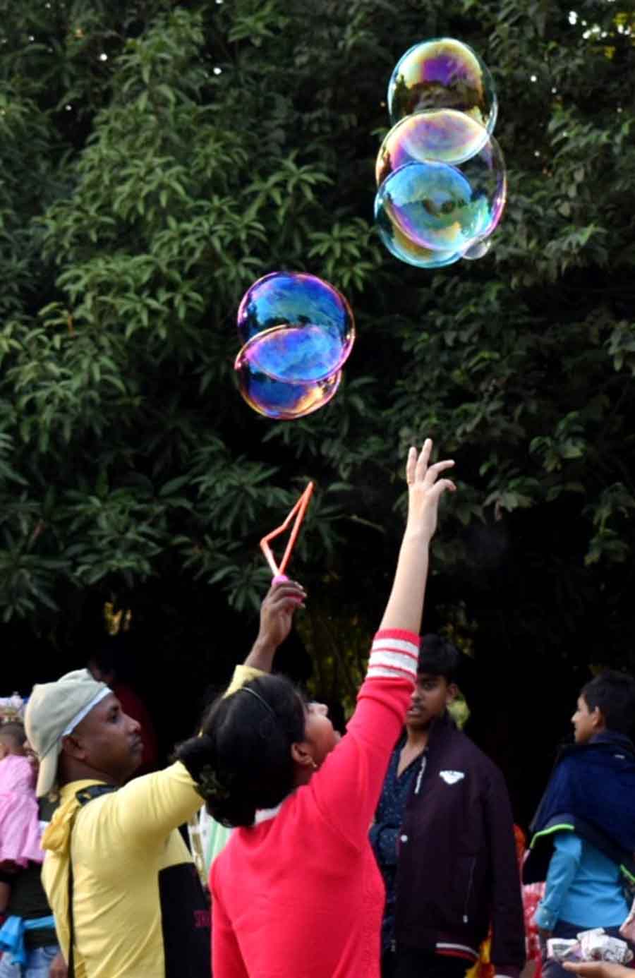A man sells soap bubble water guns near Victoria Memorial Hall on Friday