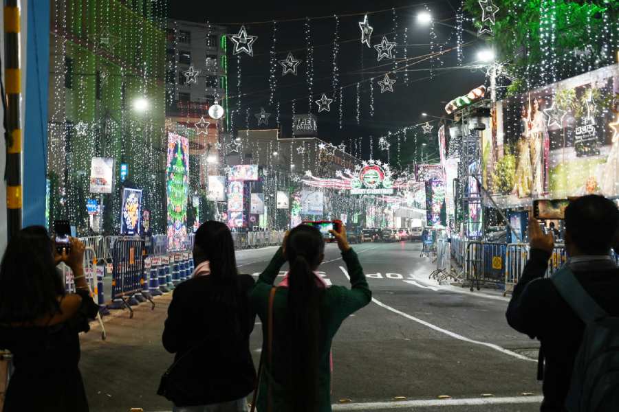 Visitors to Park Street take pictures of the illuminations on Friday.