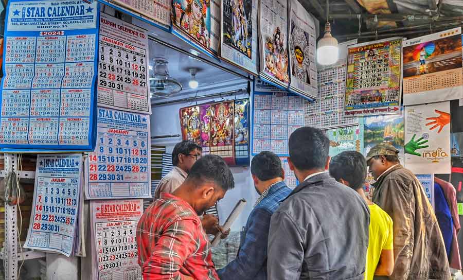 People throng a shop at Esplanade selling calendars and almanacs for 2024 on Saturday