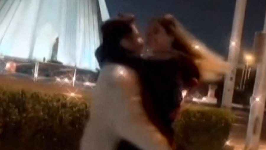 A still from a video in which Astiyazh Haghighi and her fiance Amir Mohammad  Ahmadi dance in front of Tehran's Azadi Tower
