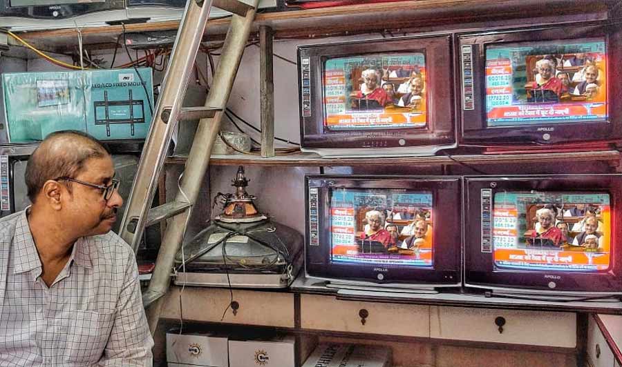 A man watches live telecast of the Union Budget 2023 at a TV repairing shop on Wednesday. The budget was presented by Union finance minister Nirmala Sitaraman on February 1, 2023. This is the last full-fledged budget before the 2024 Lok Sabha election