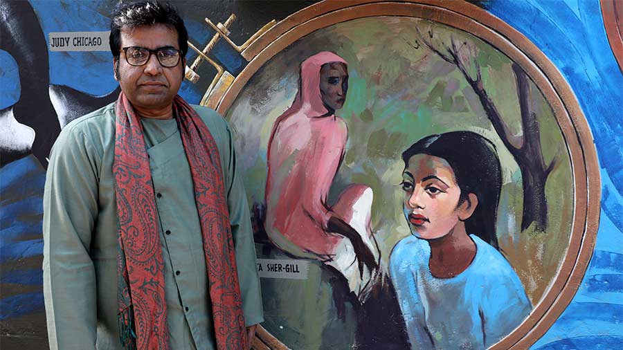 Samindra Nath Majumdar poses in front of a graffiti wall