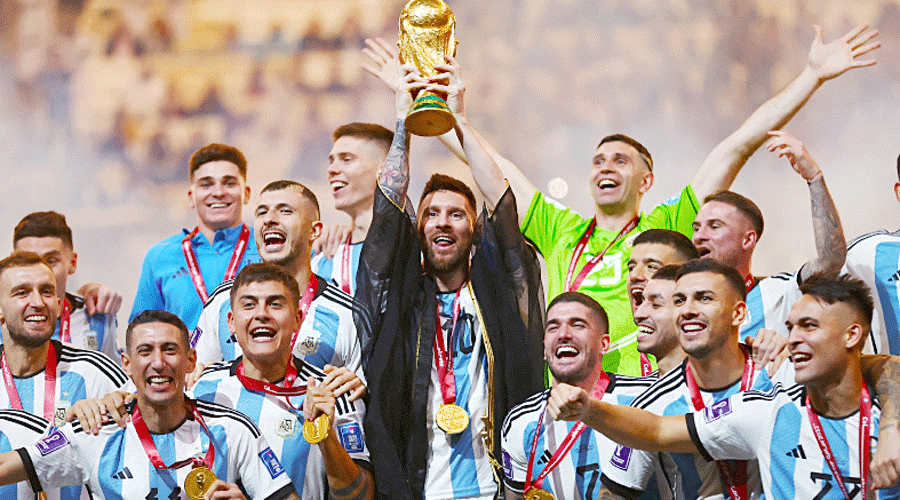 Argentina’s Lionel Messi lifts the World Cup, alongside teammates, at the Lusail Stadium on December 18.
