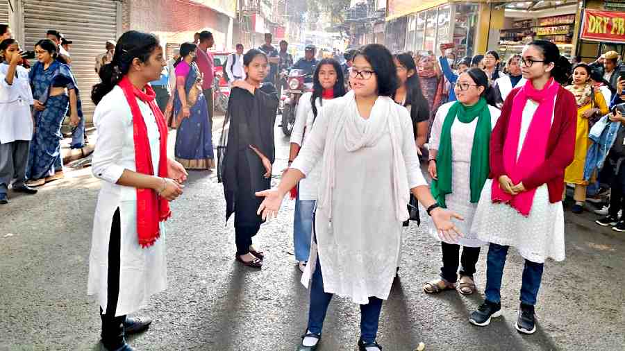 Students stage a play against child labour on Rafi Ahmed Kidwai Road