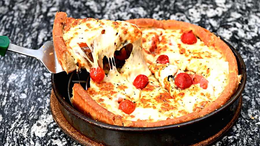 In-fresco Deep Dish Pizza made with fresh basil, pesto sauce, fresh mozzarella, caramelised onions and cherry tomatoes. A must-try for sure.