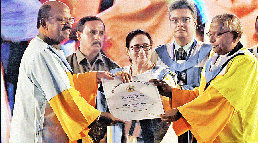 Chief minister Mamata Banerjee being awarded DLitt (honoris causa) by (right) St Xavier’s University vice-chancellor Father Felix Raj at the university’s convocation on Monday. To the chief minister’s right is governor CV Ananda Bose.