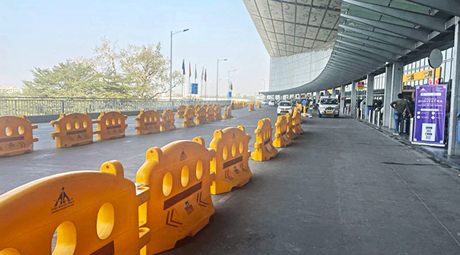 Guard rails to create lanes in front of the terminal building on the departure level of the Kolkata airport.
