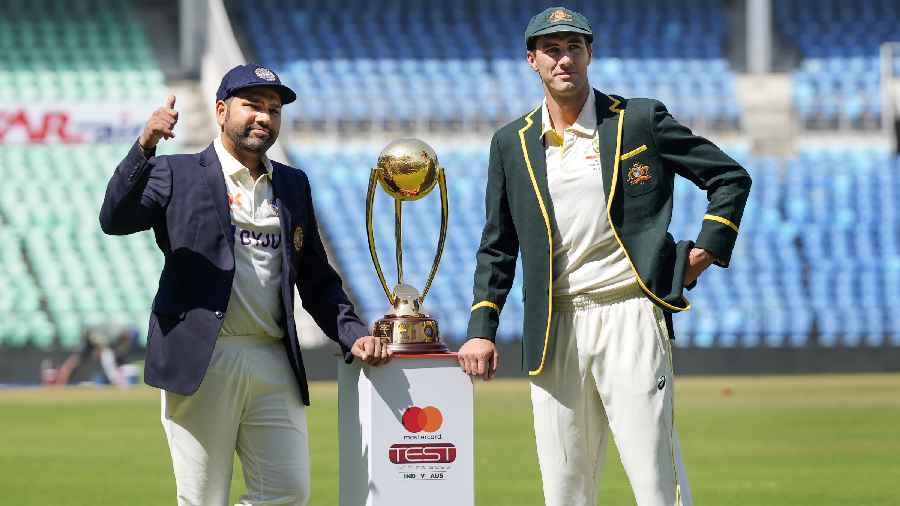 Indian captain Rohit Sharma with his Australian counterpart Pat Cummins poses for photos with the trophy ahead of the 1st cricket test match between India and Australia, at Vidharba Cricket Stadium in Nagpur, Maharashtra