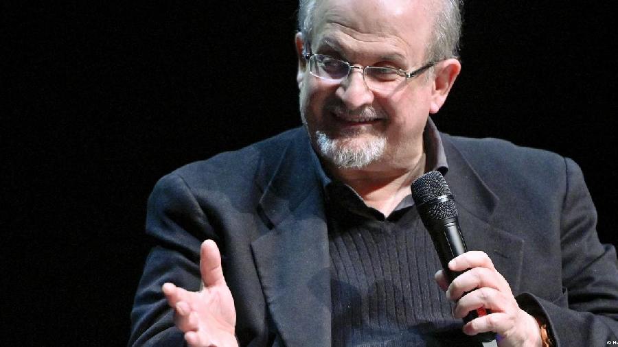 Salman Rushdie holding a a microphone