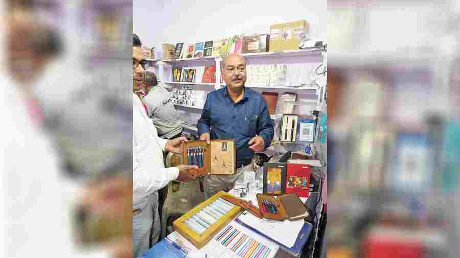 Kaushik Maitra (in blue shirt) displays fountain pens.  