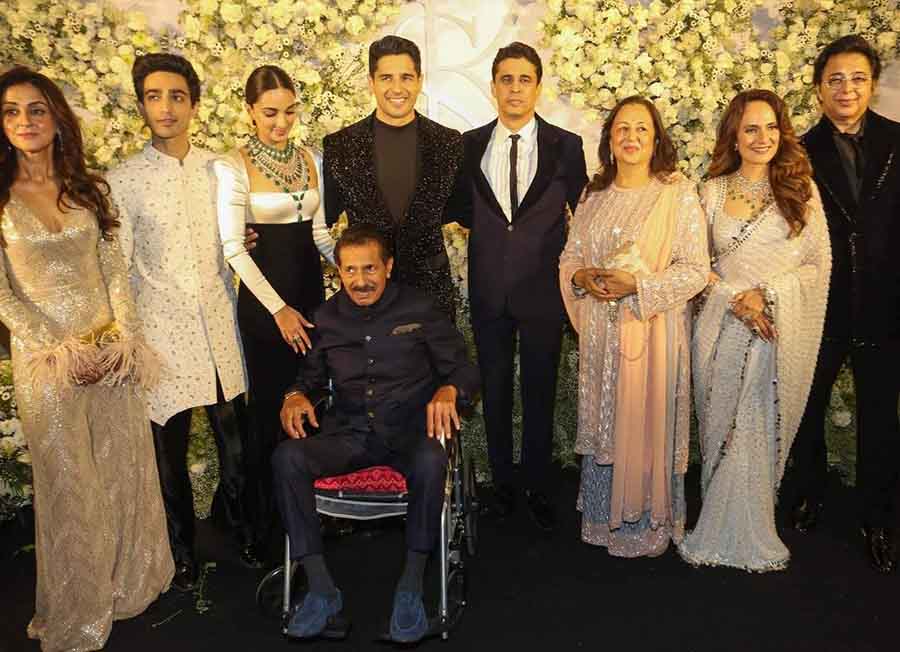 The newlyweds posed with their family members.