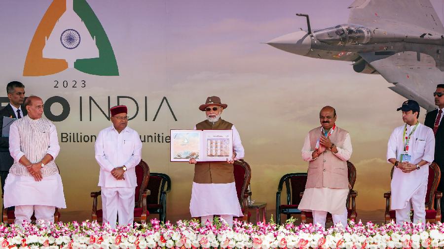Prime Minister Narendra Modi releases commemorative stamps during the inauguration of Aero India 2023, at Yelahanka air base. Defence Minister Rajnath Singh, Union Minister for Civil Aviation Jyotiraditya Scindia, Union MoS for Defence Ajay Bhatt, Karnataka Governor Thaawarchand Gehlot and Chief Minister Basavaraj Bommai are also seen.