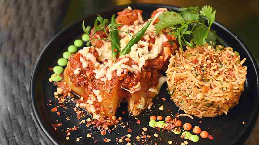 Mexican Potato is for vegetarians. It has crispy potatoes baked with spicy, flavourful sauce, drizzled with melted cheese and pepped up with a variety of seasonings, served with spicy herb rice. Rs 169