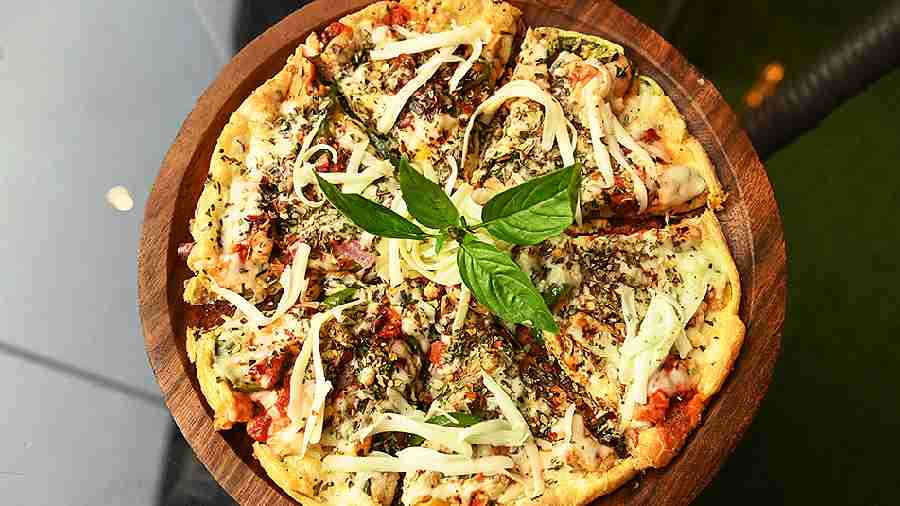 Chicken Omelette Pizza has an interesting omelette base, topped with diced chicken and mozzarella cheese. Rs 309