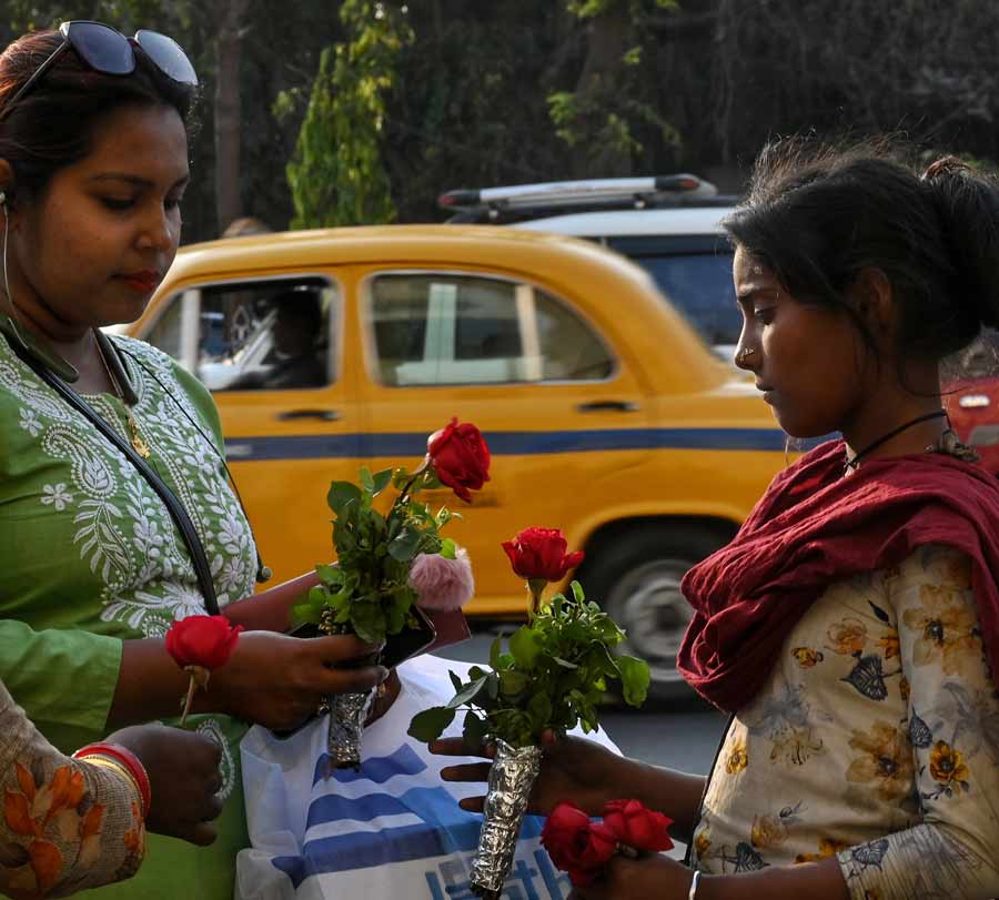 A woman buys roses from a girl. The demand for roses kept escalating and peaked on Valentine’s Day