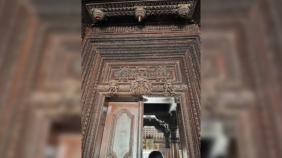 An intricately carved wooden doorway of a Chettinad mansion