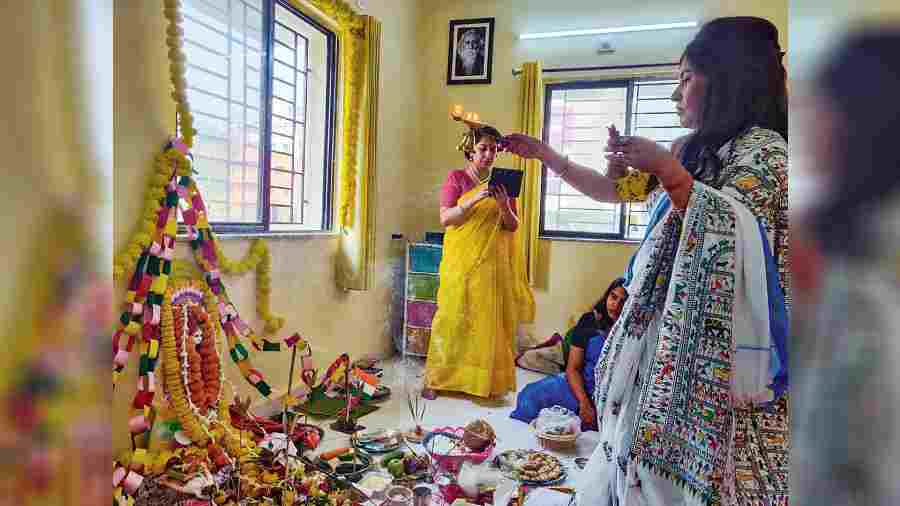 Dipika performs arati at the Saraswati puja in CB Block, New Town