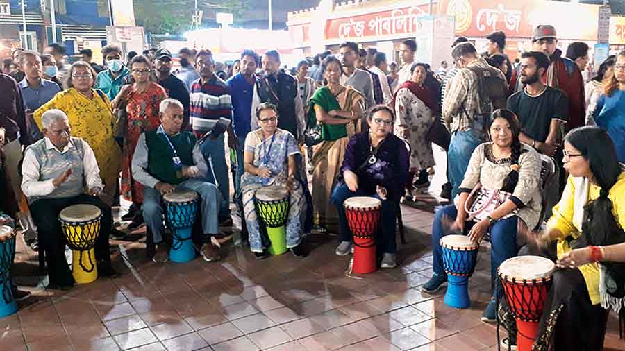 In book land: Elderly members of Saanjhbaati try their hands at playing drums at the Book Fair. 