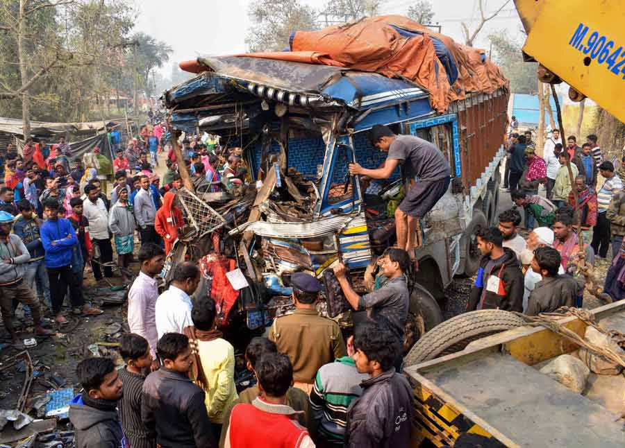 Locals check the wreckage after a truck collided with another vehicle on National Highway 512 in Malda district on Saturday. At least one person got killed and two others suffered injuries in the accident