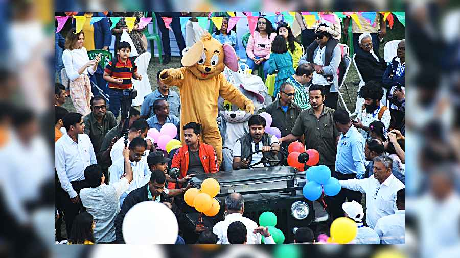 Tom and Jerry take a ride in Arihant Jain’s vintage jeep, much to the delight of the kids at the carnival.