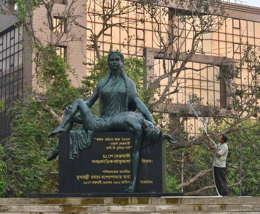 A worker cleans a sculpture that marks International Mother Language Day in front of the Birla Planetarium on Monday. Every year, International Mother Language Day is celebrated on February 21