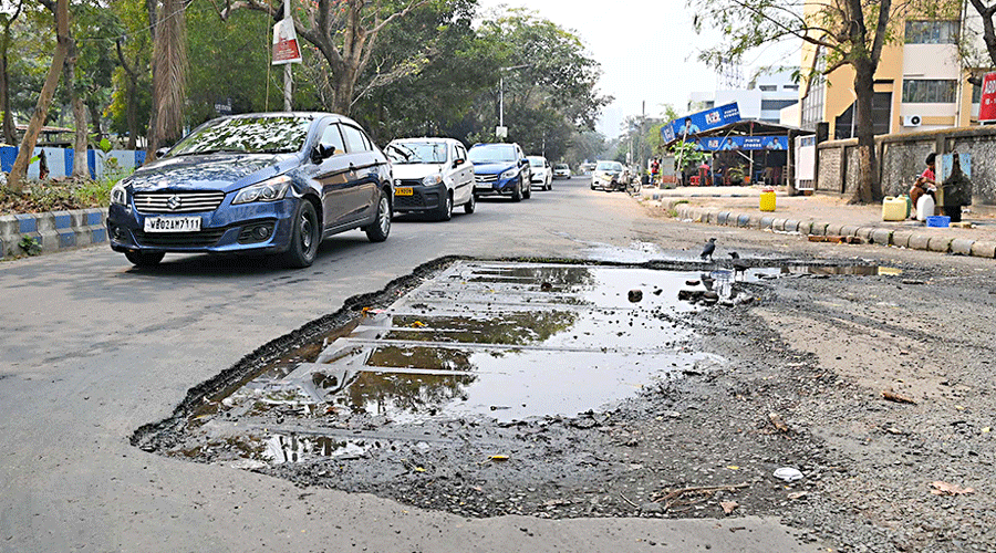 A cratered road in IB Block, near the Salt Lake stadium on Sunday. 